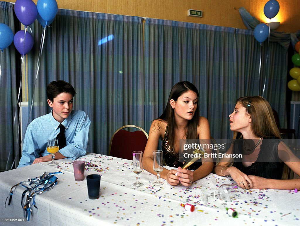 Three teenagers (14-18) at party table