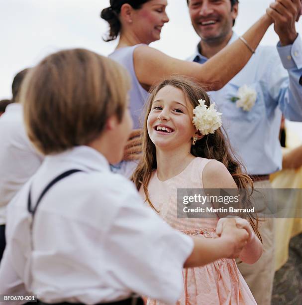 girl (8-10) dancing with boy (8-10), close-up, portrait - children dancing outside stockfoto's en -beelden