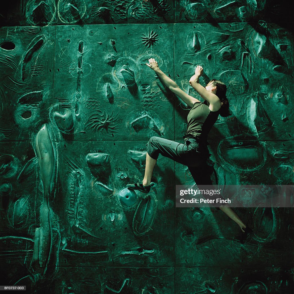 Young female climber on climbing wall