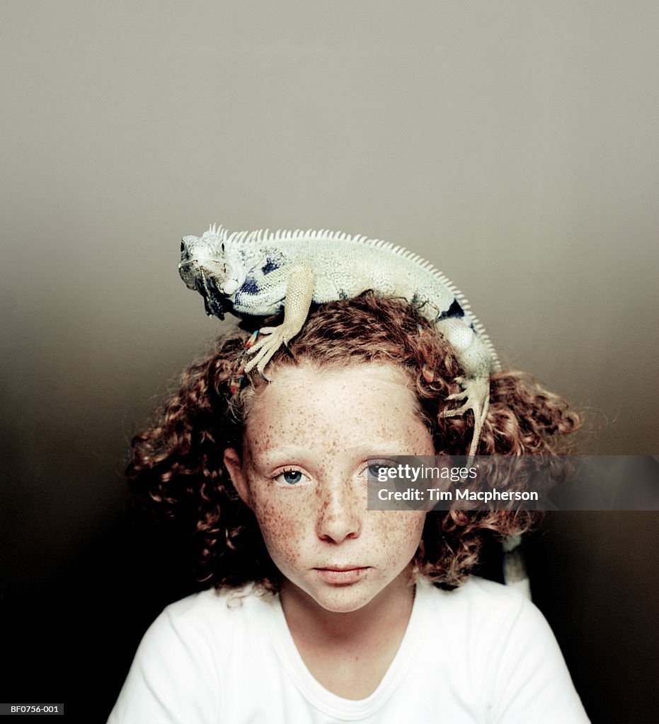 Girl (7-9) with iguana on head