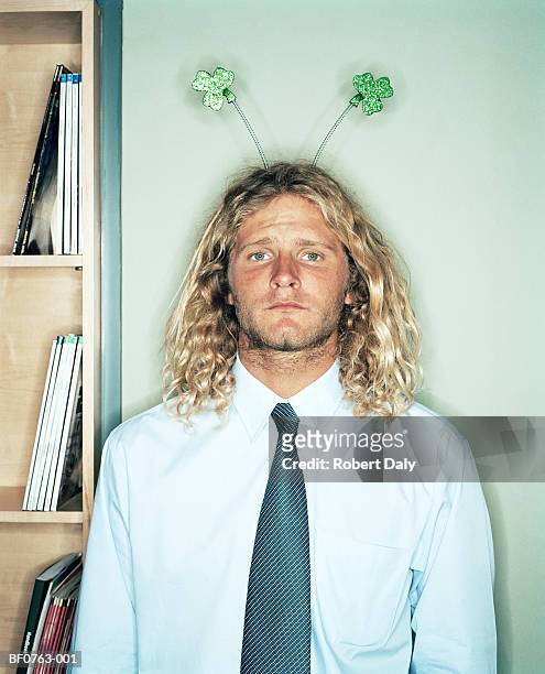 male office worker wearing shamrock deely boppers, close-up, portrait - rd 1 stock-fotos und bilder