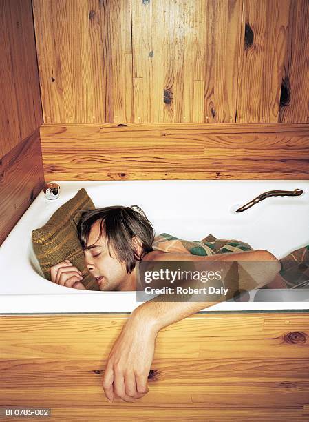 young man asleep in bath, close-up - after party mess stock pictures, royalty-free photos & images