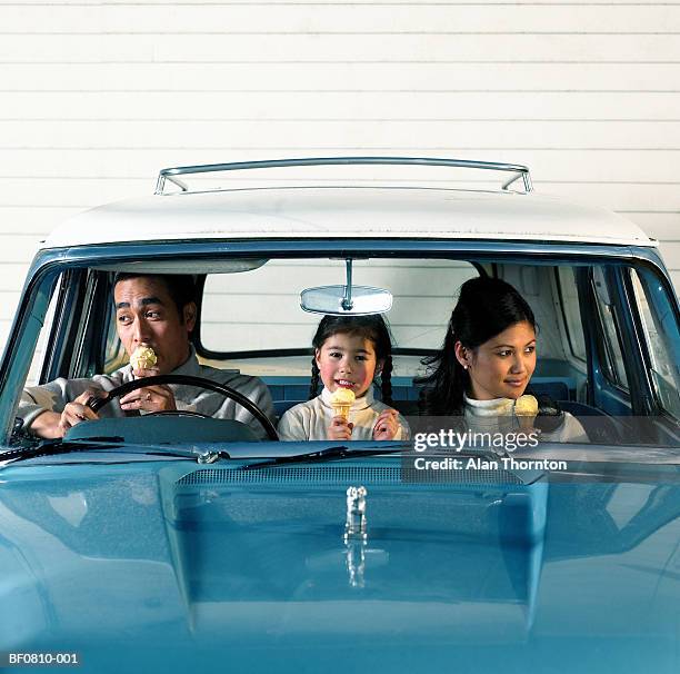 young couple with daughter (4-6) eating ice-cream in car - ice cream family stock pictures, royalty-free photos & images