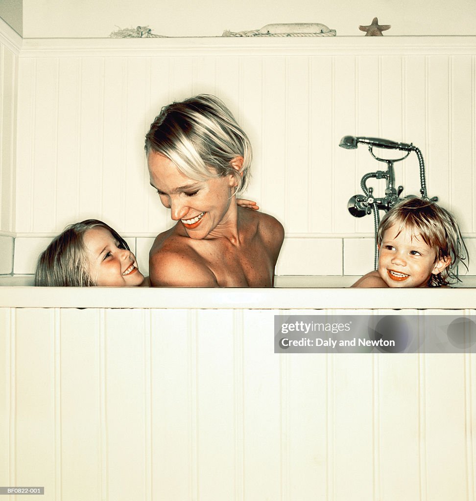 Young mother with boy and girl (4-6) in bath