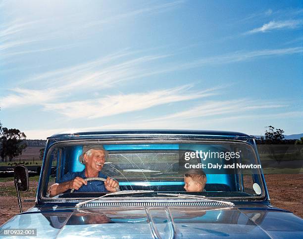 grandfather and grandson (5-7) in truck, view through windscreen - truck front view stock pictures, royalty-free photos & images