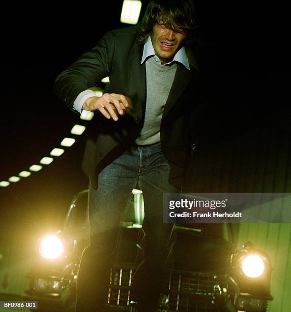man stumbling in front of car in tunnel, portrait, close-up - following car stock pictures, royalty-free photos & images