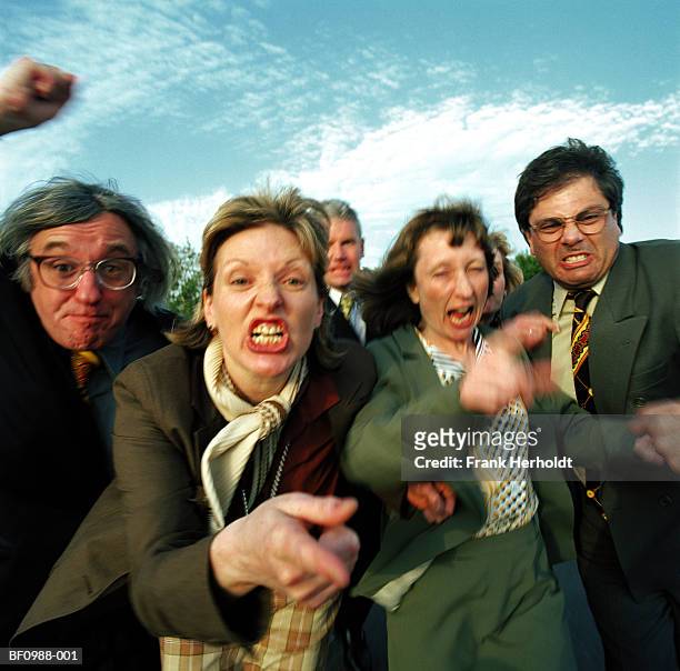 group of business people gesturing and pulling faces (blurred motion) - moue de dédain photos et images de collection