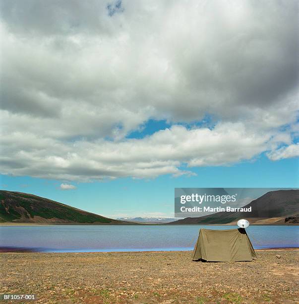 iceland, kaldidalur, tent with satellite dish pitched by lake - kaldidalur stock pictures, royalty-free photos & images