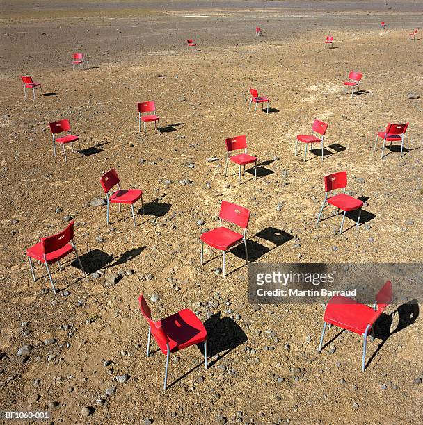 red plastic chairs dotted around desert, elevated view - kaldidalur fotografías e imágenes de stock