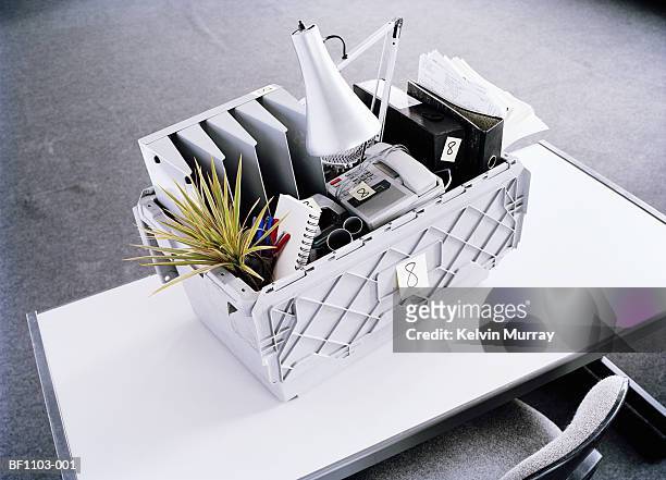 moving box filled with office equipment on desk, elevated view - moving office stock pictures, royalty-free photos & images