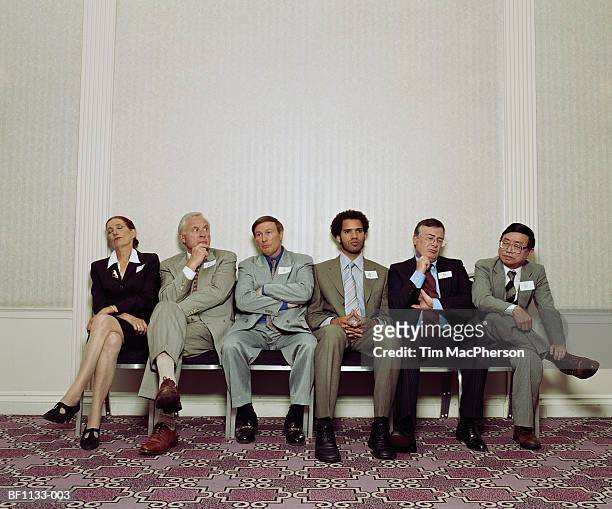 group of executives sitting in row, waiting - legs crossed at knee stock pictures, royalty-free photos & images