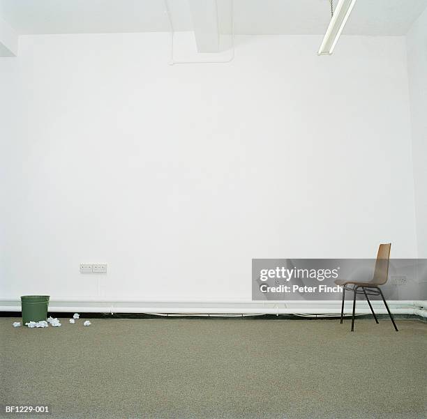 chair and waste paper basket in office, bin surrounded by paper - office carpet stockfoto's en -beelden