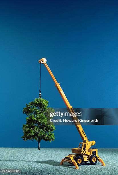 toy crane 'lifting' artificial tree, close-up - crane 個照片及圖片檔