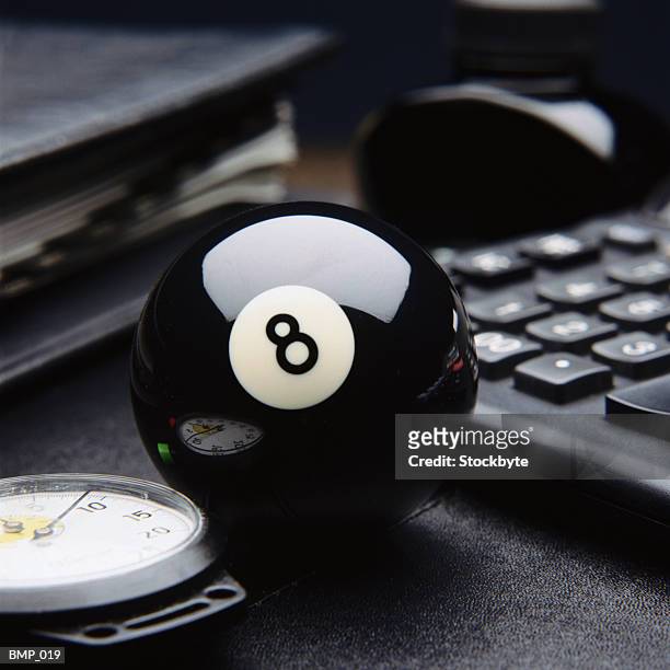 eight ball on desktop, beside stopwatch, calculator and briefcase - desk toy 個照片及圖片檔