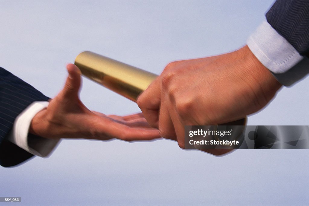 Two hands exchanging baton