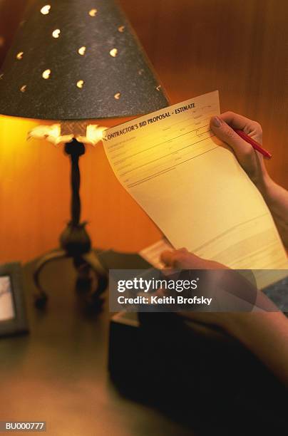 reading a bid proposal - bid proposal stock pictures, royalty-free photos & images