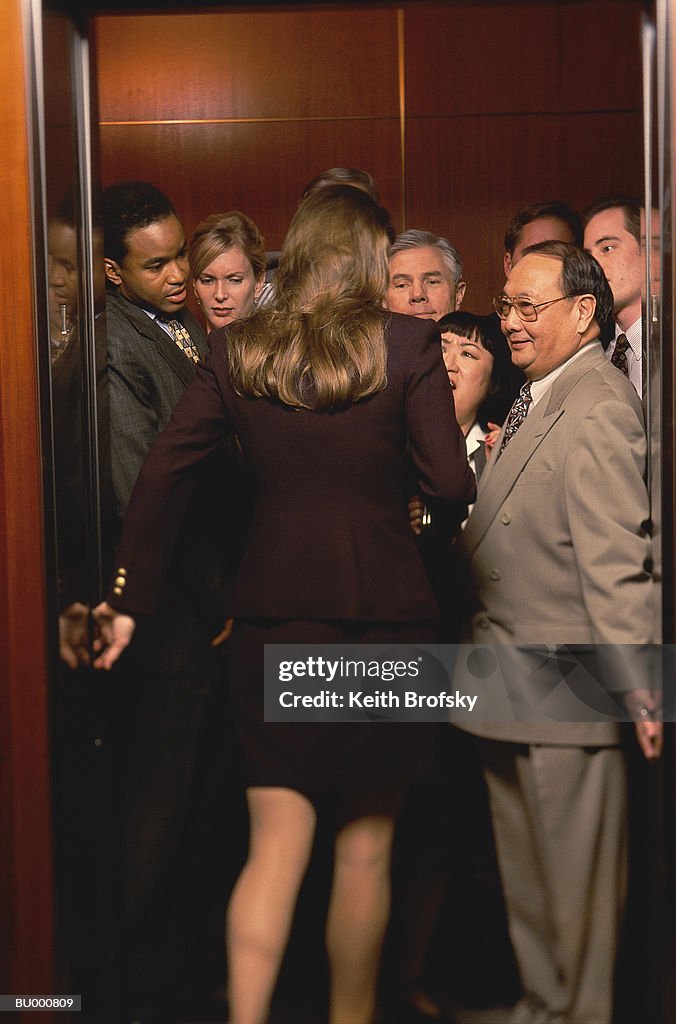 Woman Entering Crowded Elevator