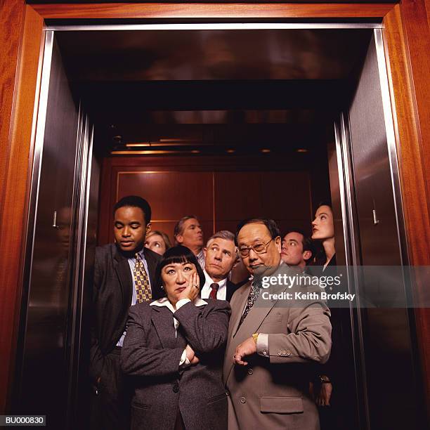 crowded elevator - crowded elevator stockfoto's en -beelden