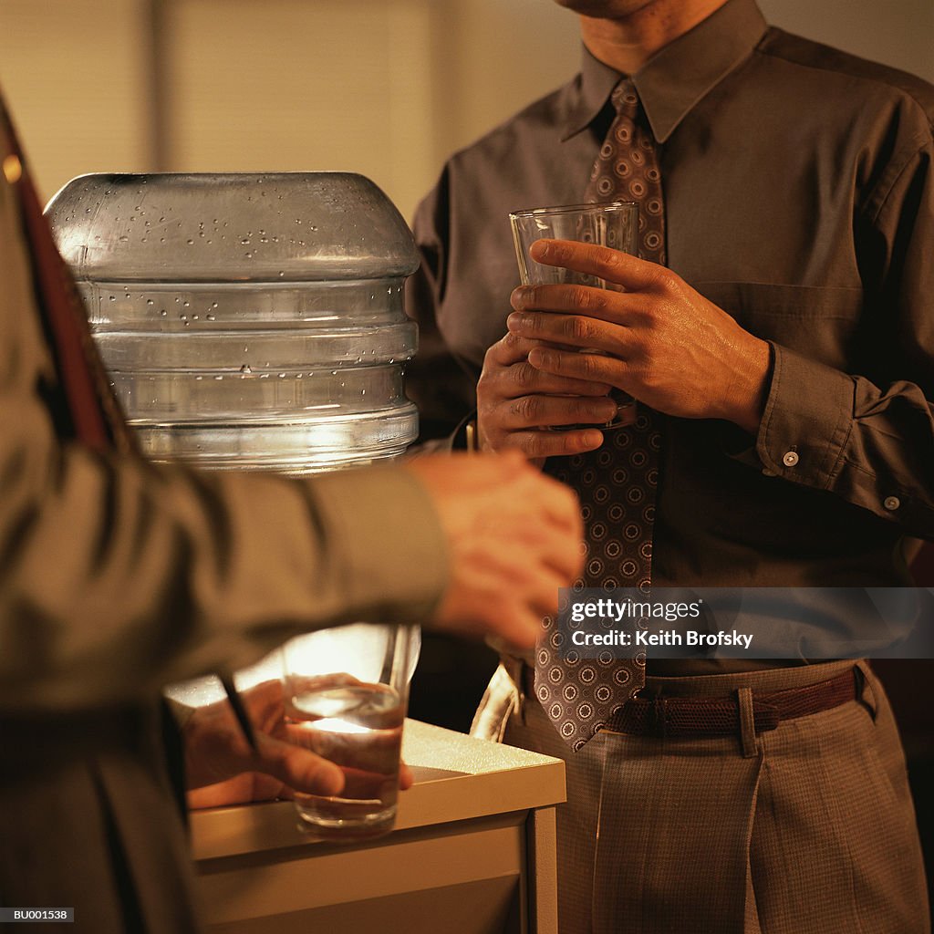 Close-Up of Businessmen at a Water Cooler