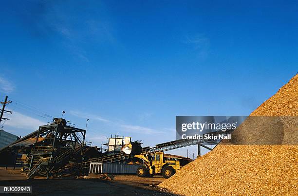 bulldozer and sawdust pile - sawdust pile stock pictures, royalty-free photos & images