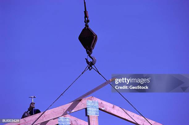 workers erecting roof trusses - claw hammer stock pictures, royalty-free photos & images