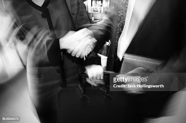 handshake and luggage blur - candid black and white corporate stock pictures, royalty-free photos & images