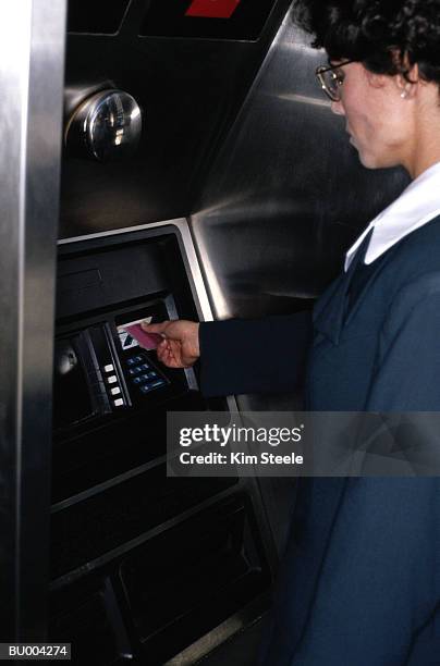 woman at automated teller machine - automated machine stock pictures, royalty-free photos & images