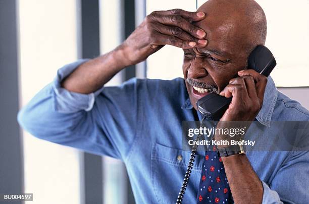 stressed businessman - angry black businessman on phone stock pictures, royalty-free photos & images