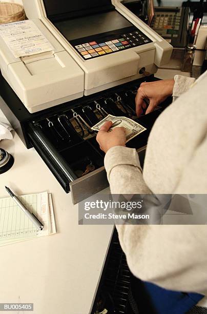 putting money in cash register - cash register stock-fotos und bilder