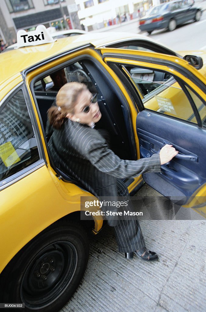 Businesswoman Exiting Taxi