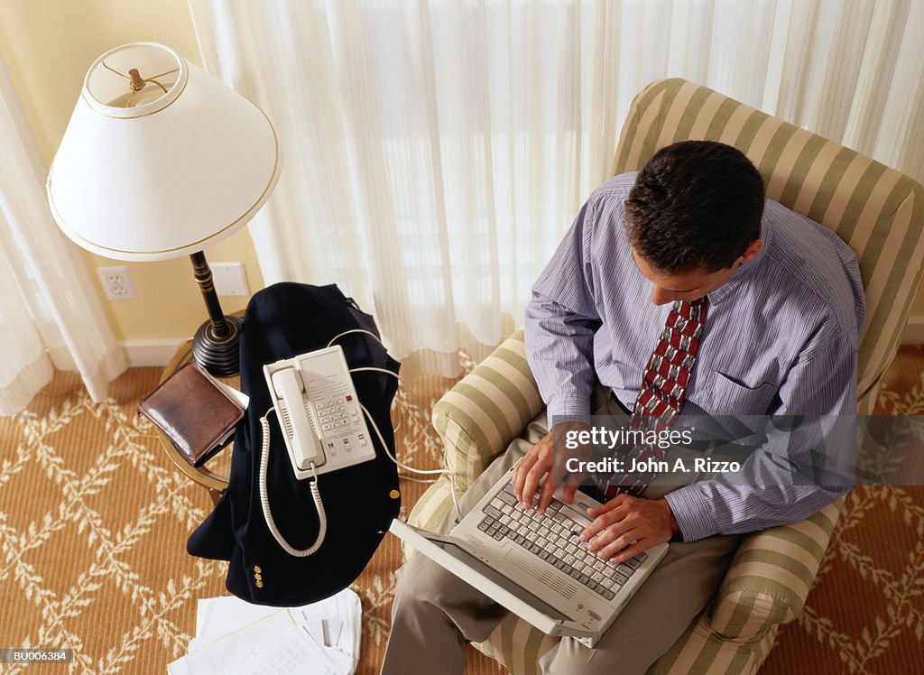 Businessman Working in Hotel Room