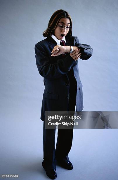 businessgirl looking at watch - adult imitation stock pictures, royalty-free photos & images