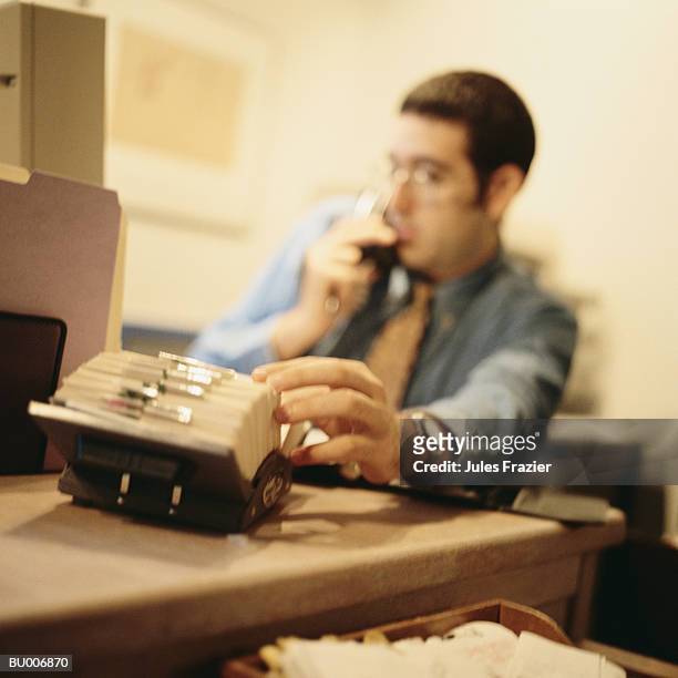 businessman searching through rotary file - searching for something ストックフォトと画像