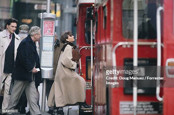 business people getting on double-decker bus - decker stock pictures, royalty-free photos & images