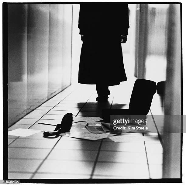 businessman leaving a briefcase and papers behind - trench coat back stock pictures, royalty-free photos & images