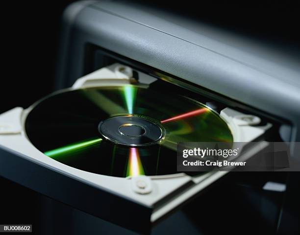 close-up of compact disc in disk drive - disk drive stock pictures, royalty-free photos & images
