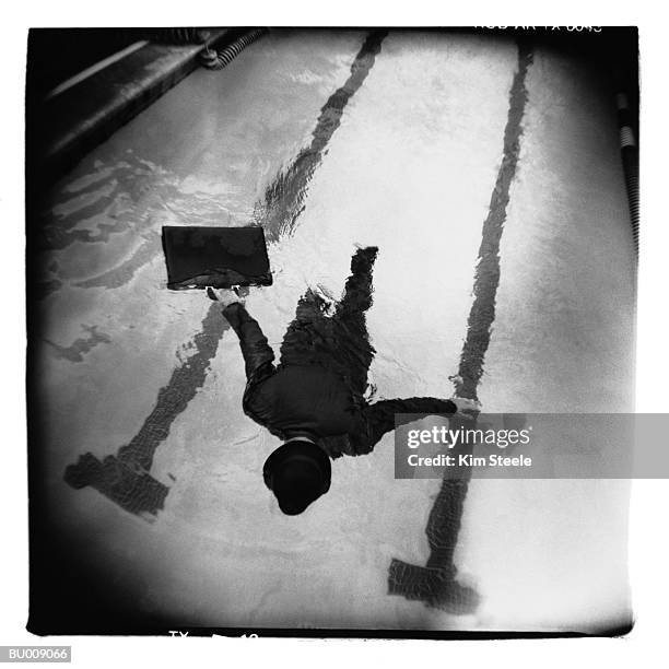businessman floating in swimming pool - wasserleiche stock-fotos und bilder