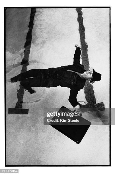 businessman floating in a swimming pool - wasserleiche stock-fotos und bilder