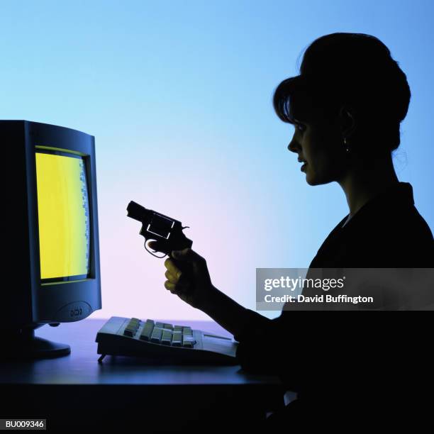 silhouette of businesswoman shooting at computer - computer rage stock pictures, royalty-free photos & images