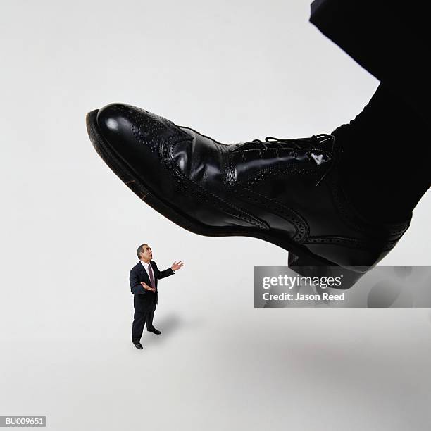 businessman getting stepped on - mens black dress shoes stock pictures, royalty-free photos & images