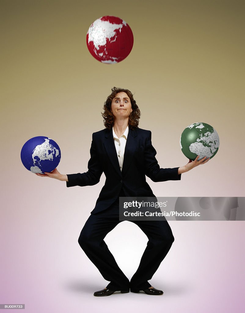 Businesswoman Juggling Globes