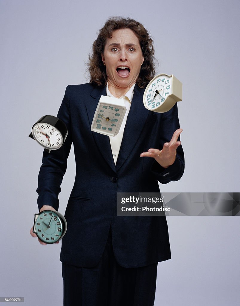 Businesswoman Juggling Clocks