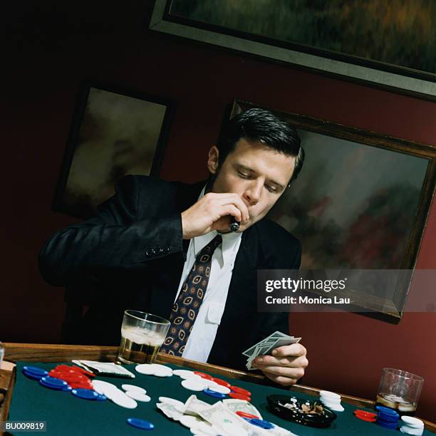 businessman at card table - card table stock pictures, royalty-free photos & images