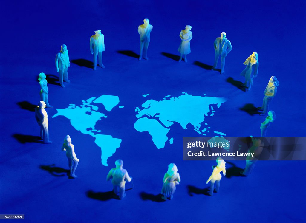 Figurines Standing in a Circle on a Map of Earth