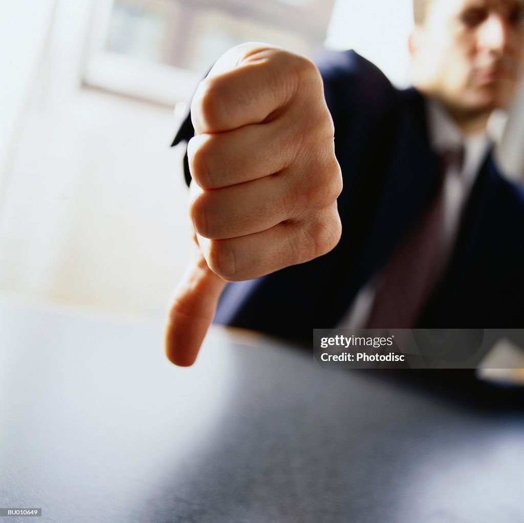 Businessman Giving the Thumbs Down Sign