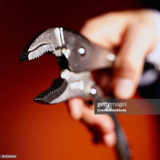 hand holding open pliers - plier stock pictures, royalty-free photos & images