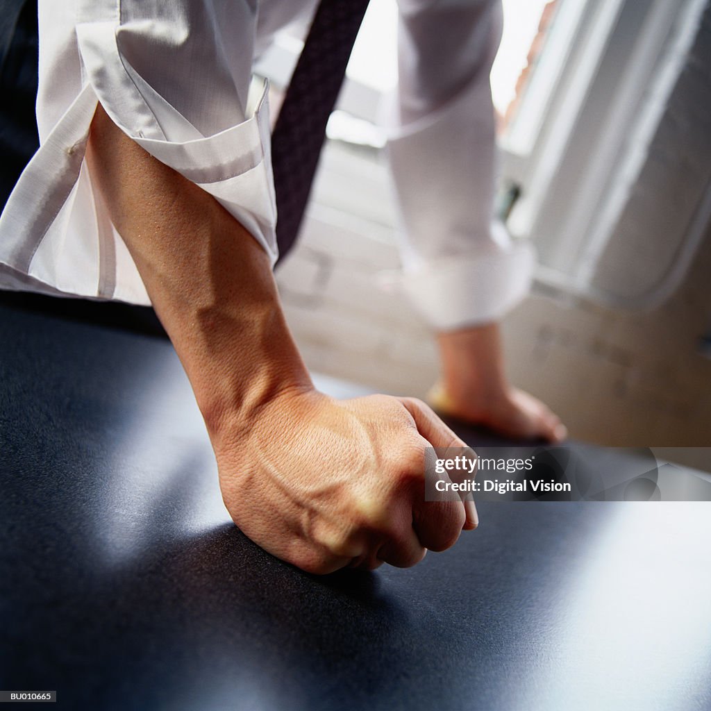 Man hitting table with fist, close-up