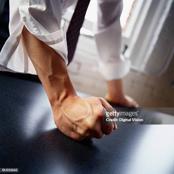 man hitting table with fist, close-up - punching imagens e fotografias de stock