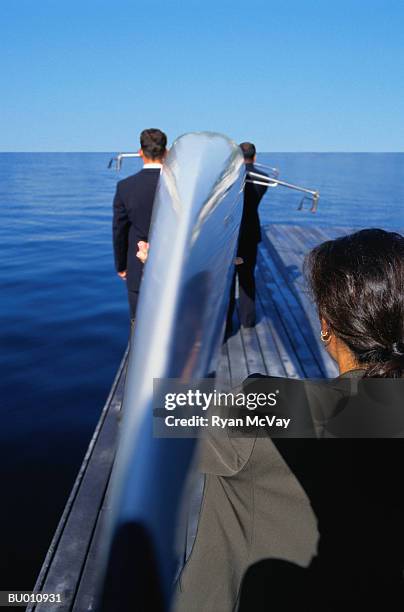 business person carrying a racing shell - 65137 stockfoto's en -beelden