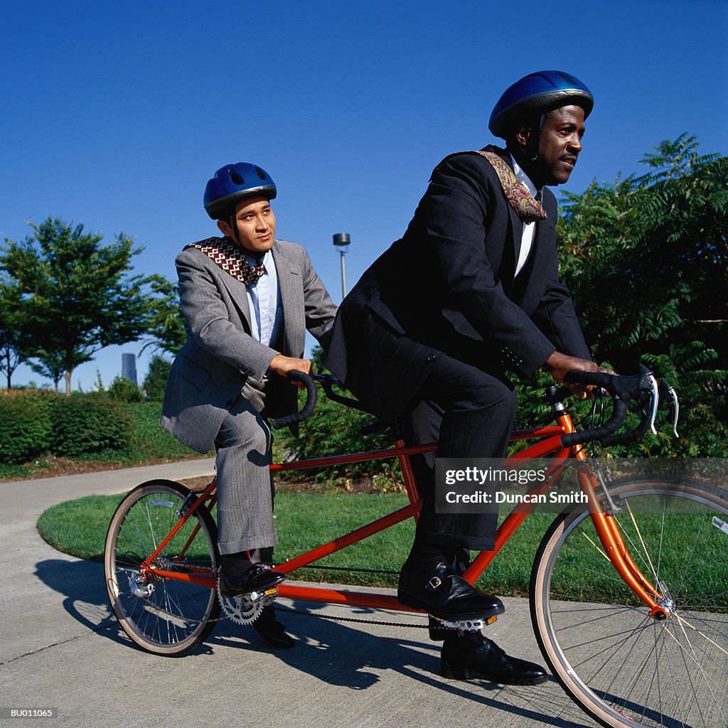 Businessmen Riding a Tandem Bicycle